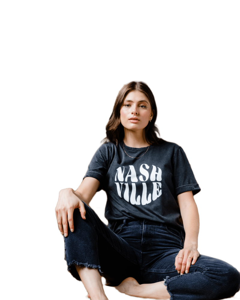 Front of a model wearing a size L Nashville Graphic Tee in Washed Black by ABLE. | dia_product_style_image_id:316026